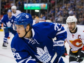 Mark Giordano of the Calgary flames hovers behind William Nylander of the Maple Leafs on Jan. 23, 2017, at the Air Canada Centre in Toronto. (ERNEST DOROSZUK/Toronto Sun).