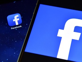The Facebook app logo is displayed on an iPad next to a picture of the Facebook logo on an iPhone in London, England, in this Aug. 3, 2016 file photo. (Carl Court/Getty Images)