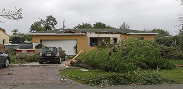 A house with roof, window and interior damage caused by severe weather in the early morning hours is viewed Monday, Jan. 23, 2017, in Miami Springs, Fla. (AP Photo/Alan Diaz)