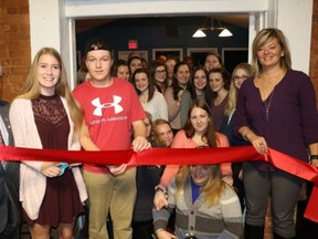 BRUCE BELL/The Intelligencer
The Prince Edward County Youth Centre officially opened on Monday night. Pictured are (left to right) Mayor Robert Quaiff, PECI students and ROC volunteers Brooke Roche and Jake Holmes along with Brandi Hodge, community engagement director of the United Way of Quinte cutting the ribbon at 299 Main St. in Picton.