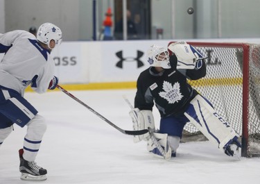 Toronto Maple Leafs Connor Brown (12) gets a shot past goalie Curtis McElhinney but pings the crossbar at practice as they prepare for their game Wednesday night in Detroit in Toronto on Tuesday January 24, 2017. Jack Boland/Toronto Sun/Postmedia Network