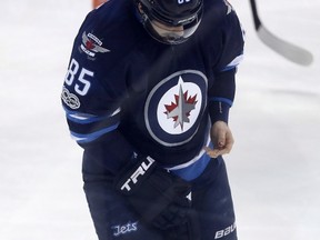 Mathieu Perreault bleeds from his thumb after taking a slash by Anaheim Ducks' Corey Perry during the first period of Monday's game. (THE CANADIAN PRESS/Trevor Hagan)