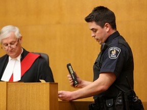 Emily Mountney-Lessard/Intelligencer file photo
Joshua Woodcock is shown here, with Justice Stephen Hunter, as he is officially sworn-in as a Belleville Police Services officer at the Quinte Consolidated Courthouse last April. Hiring practices will help the local force retain its numbers, despite impending retirements.
