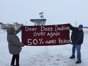 Members of Roseau River Anishinabe First Nation hold a banner protesting the lease arrangement that manager David Doer has with the Roseau River Anishinabe First Nation to run the Red Sun Smoke Shop and Gas Bar. (GLEN DAWKINS/Winnipeg Sun)