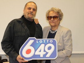 Bahadur Sultani (left) and Aghdas Mehdizadeh pose with the Lotto 6/49 logo in a handout photo. The Winnipeg man and his mother won their prize with a set of numbers that have a very special meaning to them. 
Western Canada Lottery Corporation/Handout