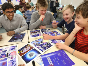 Dr. Kumanan Wilson, a senior scientist in clinical epidemiology at the Ottawa Hospital Research Institute, talks to students at Broadview Public School. (Tony Caldwell, Postmedia)