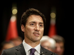 Prime Minister Justin Trudeau speaks with media during the federal Liberal cabinet retreat at the Fairmont Palliser in Calgary, Alta., on Tuesday, Jan. 24, 2017. President Donald Trump had that morning signed executive actions to advance the Keystone XL pipeline. (Lyle Aspinall/Postmedia Network)