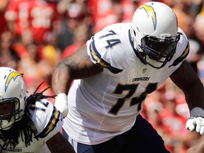 San Diego Chargers wide receiver Travis Benjamin is tackled by Kansas City Chiefs linebacker Frank Zombo, with San Diego Chargers offensive guard Orlando Franklin running in the rear, during the first half of an NFL football game in Kansas City, Mo., Sunday, Sept. 11, 2016. (THE CANADIAN PRESS/AP/Charlie Riedel)