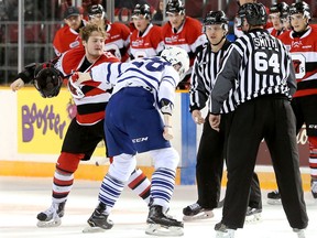Ottawa 67’s Tye Felhaber (left) mixes it up with Mississauga Steelheads’ Matthew Titus during the first period last night at TD Place. (Julie Oliver/Postmedia Network)