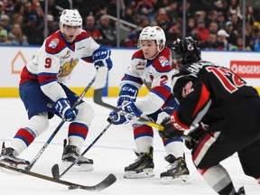 Edmonton Oil Kings Riley Stadel (centre) and Artyom Baltruk (left) chase a puck alongside Moose Jaw Warriors' Jayden Halbgewachs at Rogers Place on Sunday, Jan. 22, 2017. (Ian Kucerak)