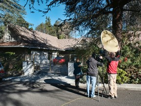 A local news crew reports from a house in the Woodland Hills section of Los Angeles on Tuesday, Jan. 24, 2017. Homicide detectives are investigating the death of Fabio Sementilli, an internationally known hairdresser and beauty company executive found beaten and stabbed outside his Los Angeles home. Police say paramedics found Sementilli bleeding profusely Monday afternoon at the gated house in the upscale Woodland Hills neighborhood. The 49-year-old suffered multiple stab wounds and died at the scene. (AP Photo/Richard Vogel)
