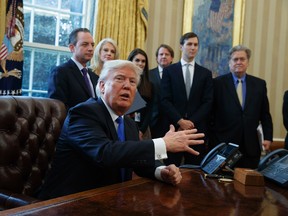 President Donald Trump talks with reporters in the Oval Office of the White House in Washington, Tuesday, Jan. 24, 2017, before signing an executive order on the Keystone XL pipeline. (AP Photo/Evan Vucci)