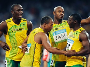 In this Friday, Aug. 22, 2008 file photo, Jamaica's gold medal winning relay team, from left, Usain Bolt, Michael Frater, Asafa Powell and Nesta Carter celebrate after the men's 4x100-metre relay final during the athletics competitions in the National Stadium at the Beijing 2008 Olympics in Beijing. Usain Bolt has been stripped of one of his nine Olympic gold medals, Wednesday, Jan. 25, 2017, in a doping case involving teammate Nesta Carter. (AP Photo/Mark J. Terrill, File)
