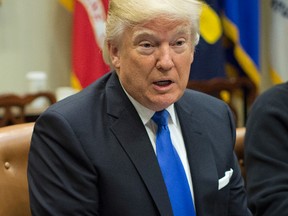 In this Tuesday, Jan. 24, 2017, file photo, President Donald Trump speaks during his meeting with automobile leaders in the Roosevelt Room of the White House in Washington. In a tweet Tuesday night Trump served notice he's ready to "send in the Feds" if Chicago can't reduce its homicide figures. (AP Photo/Pablo Martinez Monsivais, File)