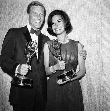 This May 25, 1964 file photo shows Dick Van Dyke, left, and Mary Tyler Moore, co-stars of "The Dick Van Dyke Show" backstage at the Palladium with their Emmys for best actor and actress in a series at the Television Academy's 16th annual awards show, in Los Angeles. Moore died Wednesday, Jan. 25, 2017, at age 80. (AP Photo, File)