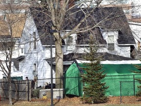 In this Jan. 17, 2017 file photo, a large green tent is seen in the back of a house on Hayward Street in Manchester, N.H., where authorities searched for clues in the missing person's case of Denise Beaudin. State authorities said the case is connected to one involving four bodies found in two steel drums between 1985 and 2000 in a state park. (Elise Amendola/AP Photo/File)