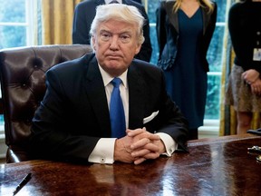 US President Donald Trump looks on after signing executive orders in the Oval Office at the White House in Washington, DC, on January 24, 2017. US President Donald Trump signed executive orders January 24, 2017 reviving the construction of two controversial oil pipelines, but said the projects would be subject to renegotiation. rump gave an amber light to the Keystone XL pipeline -- which would carry crude from Canada to US refineries on the Gulf Coast -- and an equally controversial pipeline crossing in North Dakota. (NICHOLAS KAMM/AFP/Getty Images)