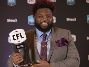 Calgary Stampeders offensive lineman Derek Dennis poses backstage after being named Most Outstanding Offensive Lineman at the CFL Awards held in Toronto on Thursday, November 24, 2016. (THE CANADIAN PRESS/Peter Power)