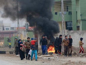 Civilians leave their neighbourhoods after fighting between Iraqi security forces and Islamic State militants in the eastern Mosul, Iraq, Wednesday, Jan. 25, 2017. (AP Photo/ Khalid Mohammed)