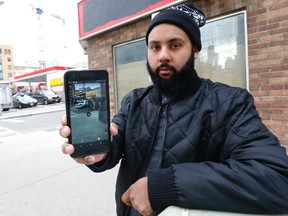 Waseem Khan on Wednesday January 25, 2017 shows his cellphone which captured a police takedown the day before in the Dundas and Church Sts. area. (Michael Peake/Toronto Sun)