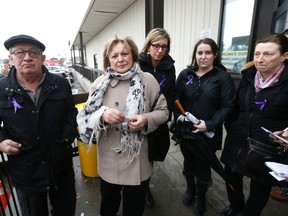 The parents and cousins of  Dr. Elana Fric-Shamji wear purple ribbons outside a North York court on Thursday, Jan. 26, 2016. Alleged killer Mohammed Shamji made a brief video appearance. (MICHAEL PEAKE/TORONTO SUN)