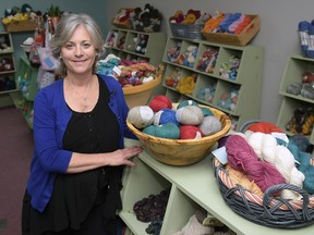 Elizabeth Poe poses in her store, The Joy of Knitting, Wed., Jan. 25, 2017, in Franklin, Tenn. Poe asked that customers go elsewhere if they want knitting supplies for the recent women's marches in which many participants wore knitted pink hats. (Shelley Mays/The Tennessean via AP)