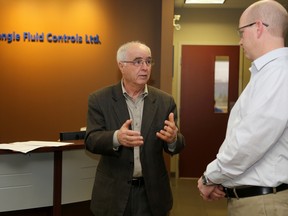 Emily Mountney-Lessard/The Intelligencer
Northumberland-Quinte West MPP Lou Rinaldi speaks to Mike Boyd, general manager of Triangle Fluid Controls, during a funding announcement on Thursday in Belleville.