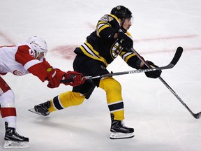 Boston Bruins left winger Brad Marchand shoots as Detroit Red Wings right winger Gustav Nyquist tries to block during an NHL game in Boston on Jan. 24, 2017. (AP Photo/Charles Krupa)