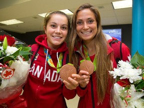 Jessie Fleming and Shelina Zadorsky, right, show off their two Olympic bronze medals earned on the women's soccer team in Rio in August. (MIKE HENSEN, The London Free Press)