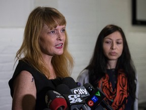 Tracey Curley, medicinal marijuana patient advocate, left, speaks with the media about wanting regulation of marijuana dispensaries as Brandy Zurborg, co-owner of Queens of Cannabis, listens on Thursday, January 26, 2017. (Craig Robertson/Toronto Sun)