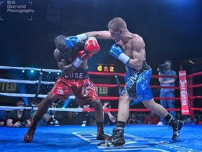 Brandon Cook (right) lands a blow to the head of Phil Rose. (Blair Diamond/photo)