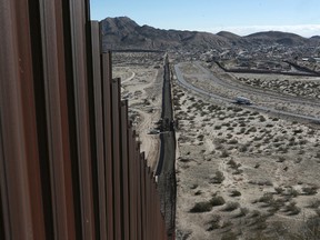 In this Jan. 25, 2017 photo, a truck drives near the Mexico-US border fence, on the Mexican side, separating the towns of Anapra, Mexico and Sunland Park, New Mexico. (AP Photo/Christian Torres)