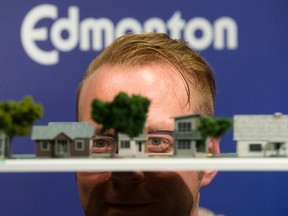 Colton Kirsop, senior planner with the city of Edmonton's zoning bylaw, development and zoning services department, poses for a photo with a model of mature neighbourhood during a press conference at City Hall, in Edmonton Thursday Jan. 26, 2017. Photo by David Bloom