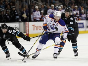 Connor McDavid of the Edmonton Oilers skates between Melker Karlsson #68 and Justin Braun #61 of the San Jose Sharks at SAP Center on Jan. 26, 2017. (Ezra Shaw/Getty Images)