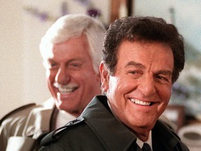 This Jan. 15, 1997 file photo, actor Mike Connors, right, appears with actor Dick Van Dyke during an episode of the television show "Diagnosis Murder," in Los Angeles. Connors, who played a hard-hitting private eye on the long-running TV series "Mannix," has died at age 91. His son-in-law, Mike Condon, says the actor died Thursday afternoon, Jan. 26, 2017, at a Los Angeles hospital from recently-diagnosed leukemia. (AP Photo/Chris Pizzello, File)