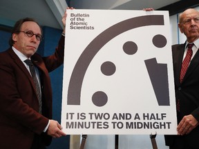 Lawrence Krauss, theoretical physicist, chair of the Bulletin of the Atomic Scientists Board of Sponsors, left, and Thomas Pickering, co-chair of the International Crisis Group, display the Doomsday Clock during a news conference at the National Press Club in Washington, Thursday, Jan. 26, 2017, announcing that the Bulletin of the Atomic Scientist have moved the minute hand of the Doomsday Clock to two and a half minutes to midnight. (AP Photo/Carolyn Kaster)