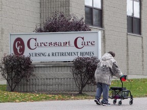 A woman walks into the Caressant Care facility in Woodstock, Ont., on Tuesday, Oct. 25, 2016. A long-term care home where a former nurse is accused of killing seven seniors has been ordered by the province to temporarily stop admitting new patients. (THE CANADIAN PRESS/Dave Chidley)