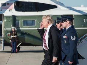 US President Donald Trump salutes as he steps off Air Force One at Andrews Air Force Base in Maryland upon his return from Philadelphia on January 26, 2017. AFP PHOTO / NICHOLAS KAMMNICHOLAS KAMM/AFP/Getty Images