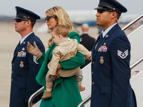 FILE - In this Jan. 19, 2017, file photo, Ivanka Trump carries her son Theodore Kushner, as they arrive at Andrews Air Force Base, Md., for her father's inauguration. Trump shared video on Instagram Jan. 25, 2017, of Theodore crawling in the White House. (AP Photo/Evan Vucci, File)