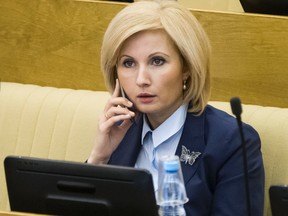 Russian lawmaker Olga Batalina, one of the bill’s co-authors, speaks on a phone at the State Duma (lower parliament house) in Moscow Friday, Jan. 27, 2017. (AP Photo/Alexander Zemlianichenko)