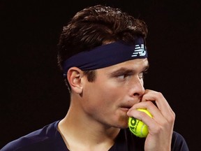 Canada’s Milos Raonic grabs a ball while playing Spain’s Rafael Nadal during their quarterfinal at the Australian Open in Melbourne Wednesday, Jan. 25, 2017. (THE CANADIAN PRESS/AP, Kin Cheung)