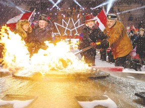 Sharon Johnston, left, Gov. Gen. David Johnston, Minister of Canadian Heritage Melanie Joly and elder Albert Dumont re-light the Centennial Flame on Parliament Hill on New Year?s Eve in Ottawa. (Justin Tang/The Canadian Press)