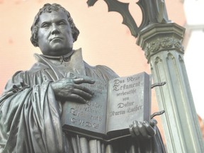 A statue of 16th-century theologian Martin Luther stands on Marktplatz Square in Wittenberg, Germany. Five hundred years ago, Luther nailed his 95 theses to a door of the nearby Schlosskirche Church, setting in motion the Protestant Reformation. (Sean Gallup/Getty Images)