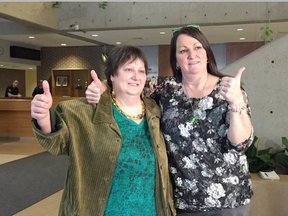 Lucie Lesage, 53, and Nathalie Lesage, 49, give a celebratory thumbs up in the Gatineau courthouse Friday, Jan. 27, 2017 after their father was sentenced to 15 years in prison. Jacques Lesage, 79, was convicted of sexually abusing Nathalie and fathering three children with his other daughter, Lucie. (Joe Lofaro/Postmedia)