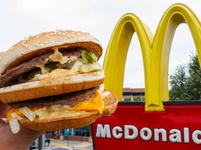 This file photo taken on August 10, 2015 shows a McDonald's Big Mac, held up near the golden arches at a McDonalds's in Centreville, Virginia. (PAUL J. RICHARDS/AFP/Getty Images)