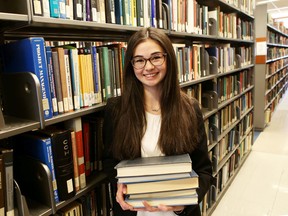Akemi Gallagher of Queen’s Students for Literacy is helping to collect used children's books to support the group's reading groups in Kingston. (Elliot Ferguson/The Whig-Standard)