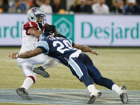 Former Alouette Arland Bruce gets drilled by Argonauts’ Major Culbert in 2013. Bruce is back in court on March 3. (Stan Behal/Postmedia Network)