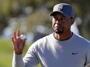 Tiger Woods reacts to the crowd after finishing the 11th hole of the North Course during the second round of the Farmers Insurance Open on Jan. 27, 2017, at Torrey Pines Golf Course in San Diego. (AP Photo/Gregory Bull)