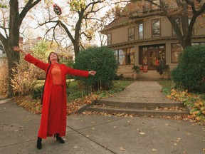 This photo taken in 1996 shows Mary Tyler Moore tossing her hat up as she revisits the Minneapolis Kenwood neighborhood house which was her television "home" for the television show The Mary Tyler Moore Show some 25 years ago. (Cheryl A. Meyer/Star Tribune via AP)
