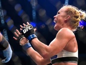 Holly Holm celebrates after defeating Ronda Rousey during their UFC 193 bantamweight title fight in Melbourne, Australia on Nov. 15, 2015. (AP Photo/Andy Brownbill)